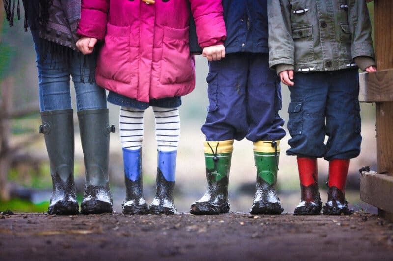 Picture of some kids in wellies. Interacting with their grandkids can be good for elderly people.