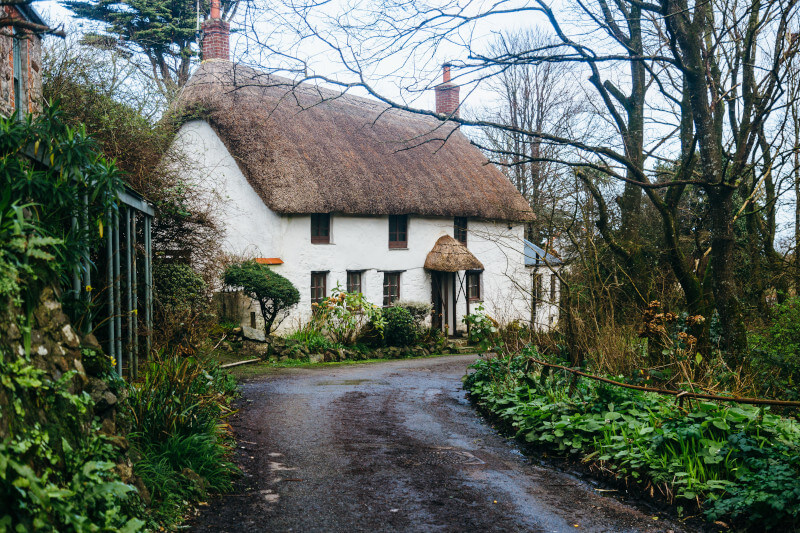 A white thatched cottage at the end of a quiet lane, the kind of home a domestic support worker visits