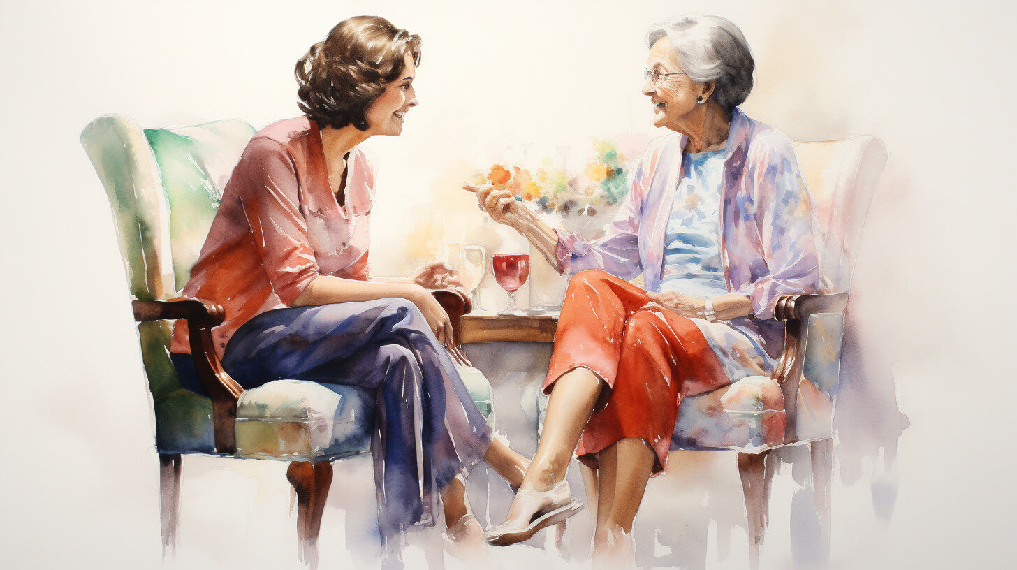 A carer and the person she supports sitting together in armchairs in a comfortable living room, talking over drinks set out on a small table between them
